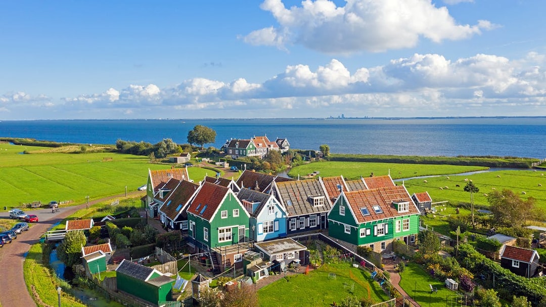 Traditional Dutch houses near the sea in Marken, part of Volendam Cheese Factory Tours.