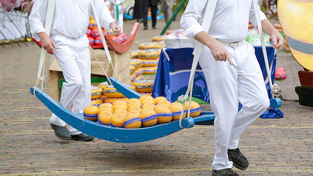 Cheese carriers at a market in Edam during the Zaanse Schans, Edam, Volendam & Marken tour.