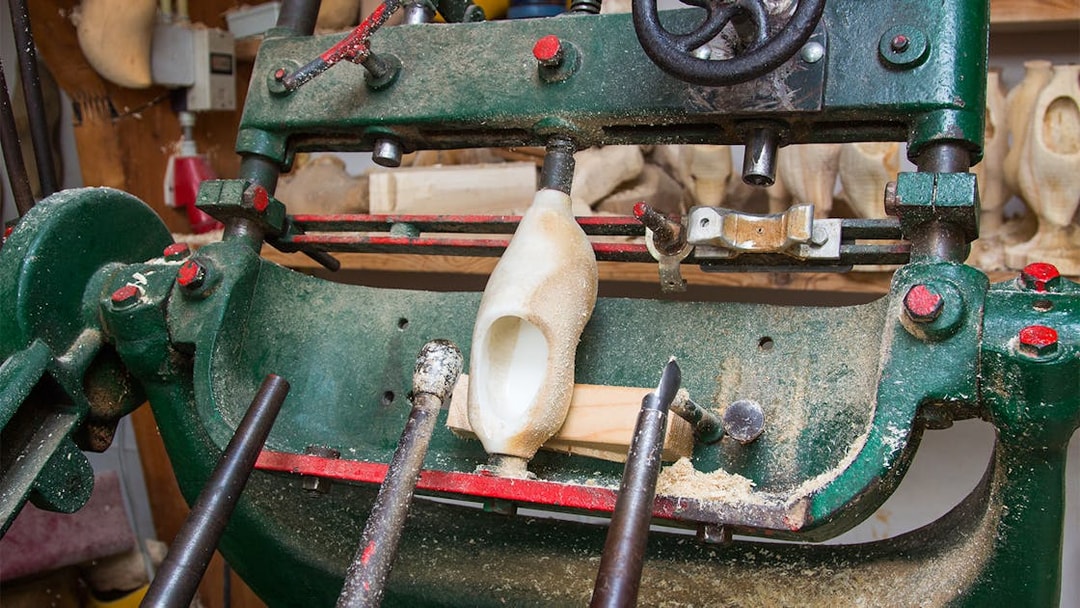 Wooden clog being crafted on a machine in Zaanse Schans, Netherlands.