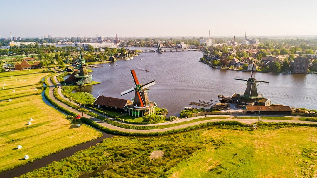 Traditional Dutch windmills along a river at Zaanse Schans, Netherlands.