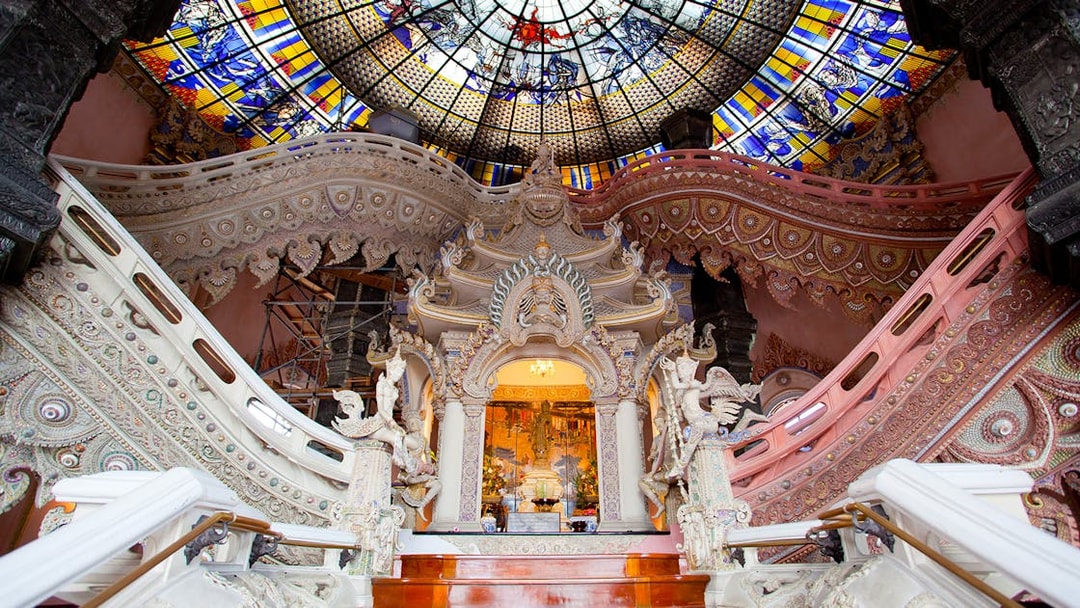 Erawan Museum interior with ornate staircase and stained glass ceiling, Bangkok, Thailand.
