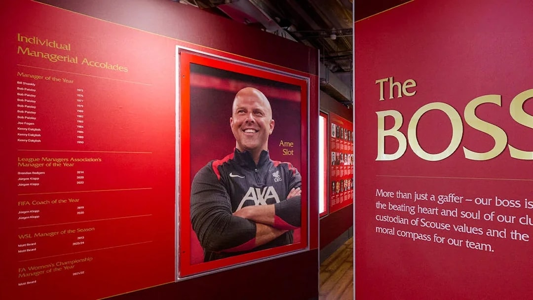 Liverpool FC Stadium tour exhibit featuring managerial accolades and a portrait of a coach.