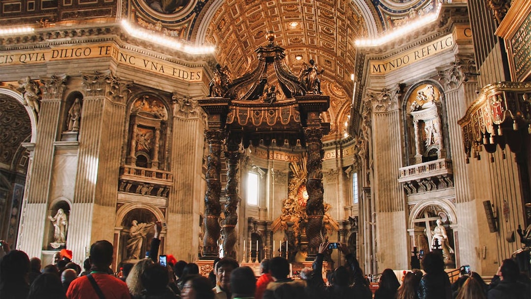 Interior of St. Peter's Basilica with tourists, featured on the Official Angels & Demons Tour.