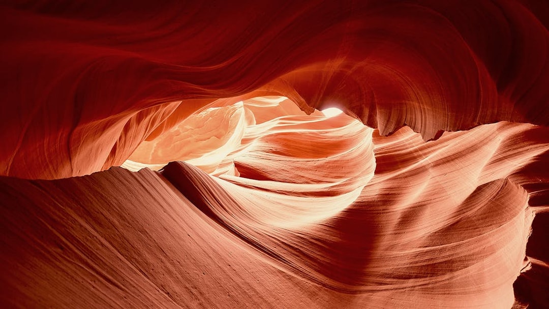 Upper Antelope Canyon's swirling sandstone formations illuminated by sunlight.