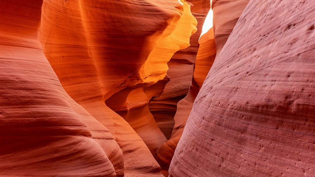 Antelope Canyon X sandstone formations illuminated by sunlight.