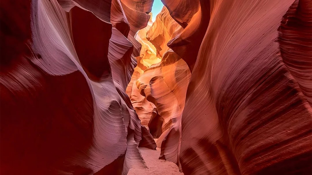 Tourists exploring Lower Antelope Canyon's unique rock formations with admission tickets.