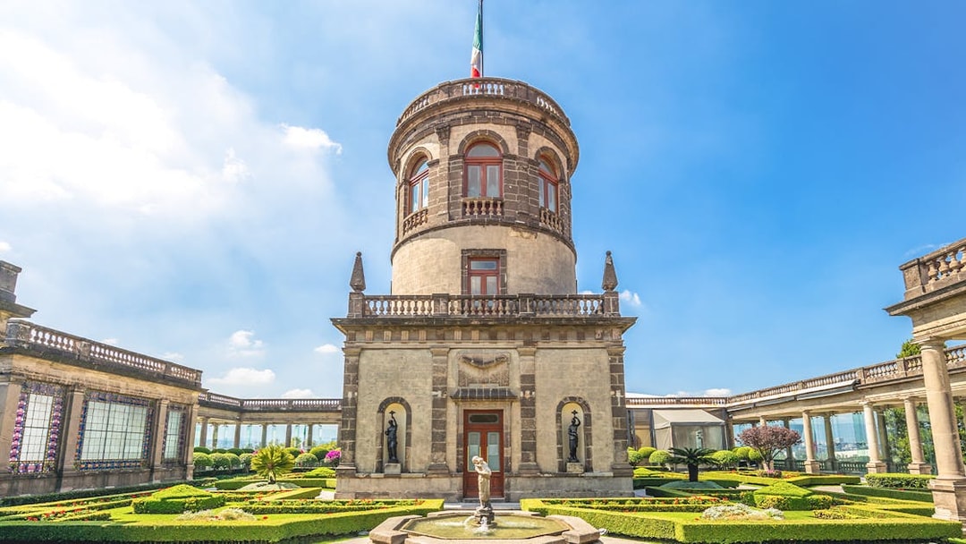 Chapultepec Castle tower in Mexico City with surrounding gardens and historic architecture.