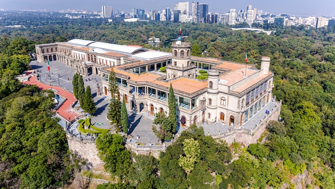 Chapultepec Castle in Mexico City surrounded by lush gardens and historic architecture.