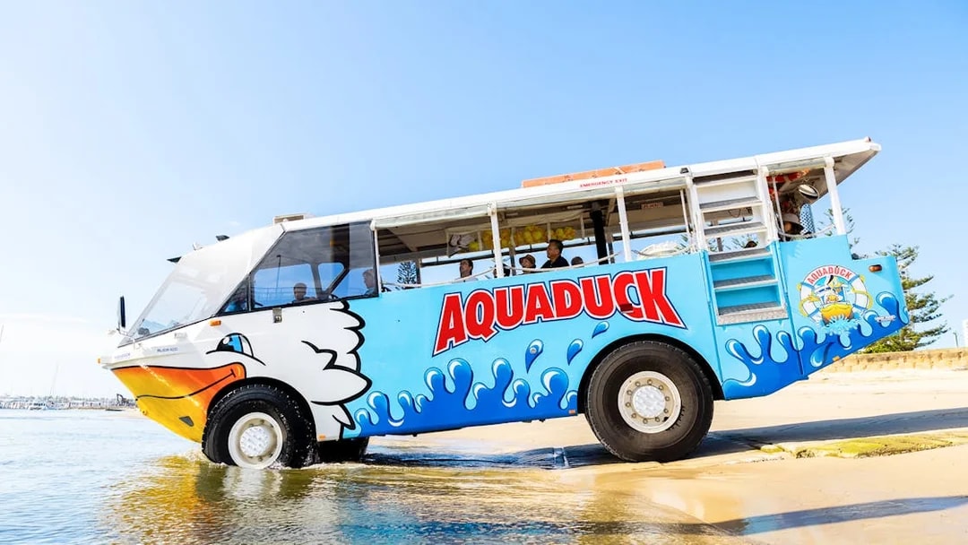 Aquaduck amphibious vehicle entering water for city tour and river cruise.