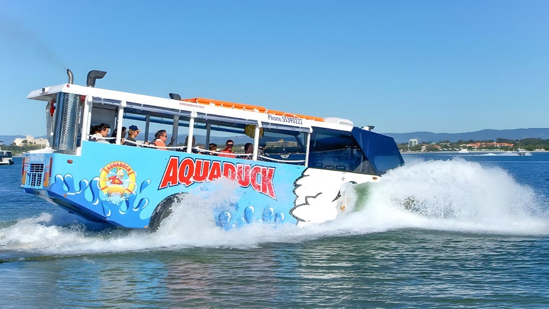 Aquaduck amphibious vehicle cruising on a river during a city tour.