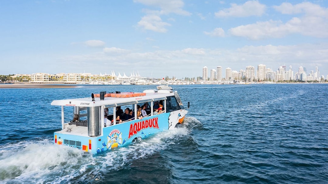 Aquaduck tour boat sailing near Sunshine Coast skyline.
