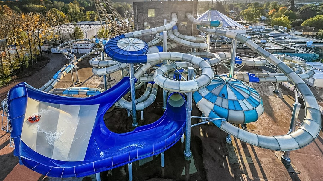Tourists enjoying water slides at Aqualibi park.