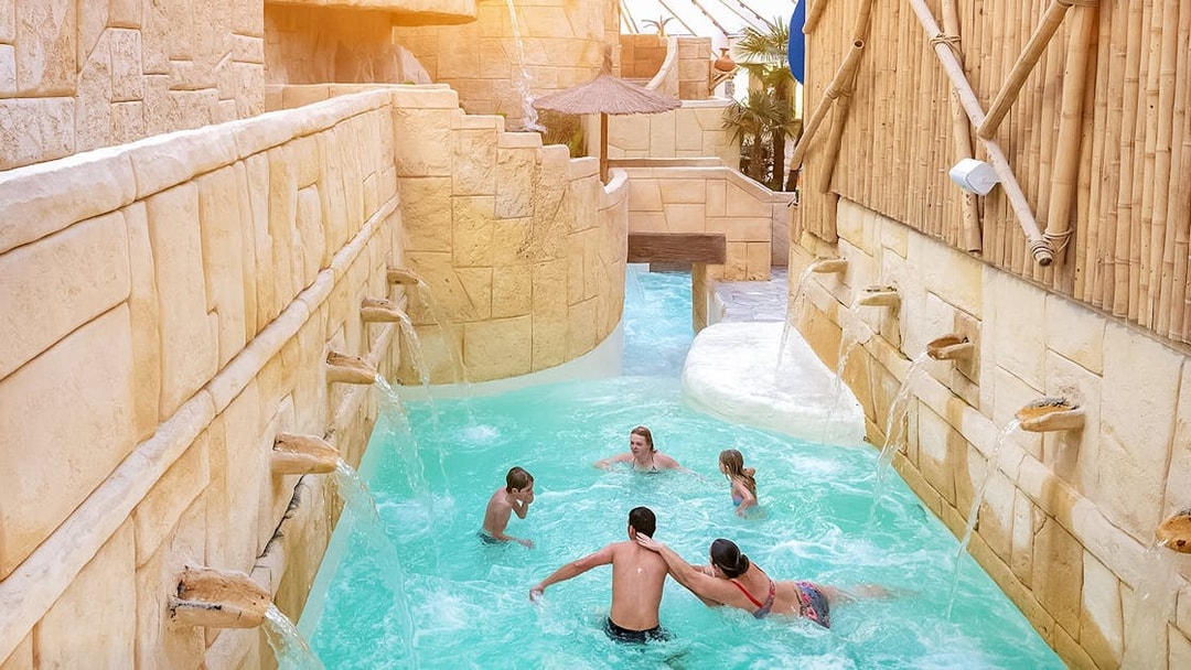Tourists enjoying the water rapids at Aqualibi.