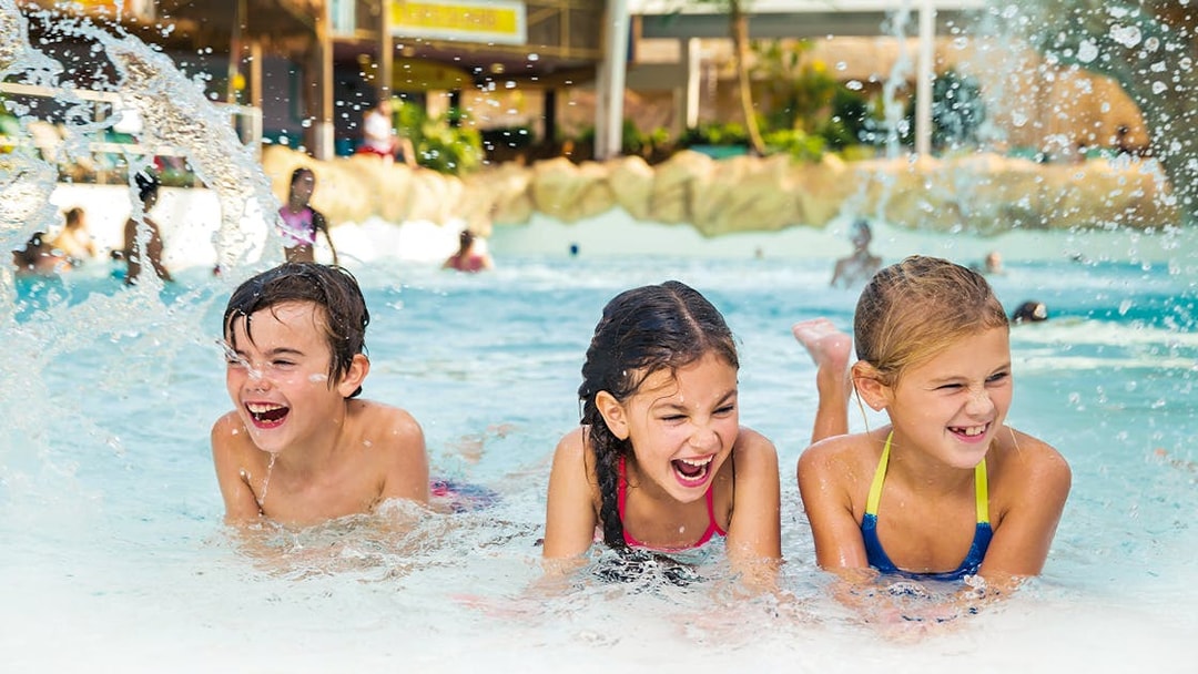 Kids playing in the wave pool at Aqualibi water park.