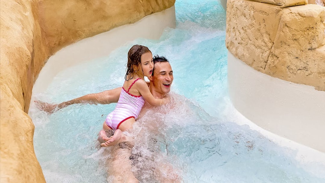 Family enjoying the Rapido slide at Aqualibi water park.