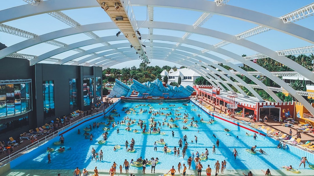 Visitors enjoying the wave pool at Aquashow Water Park, Portugal.