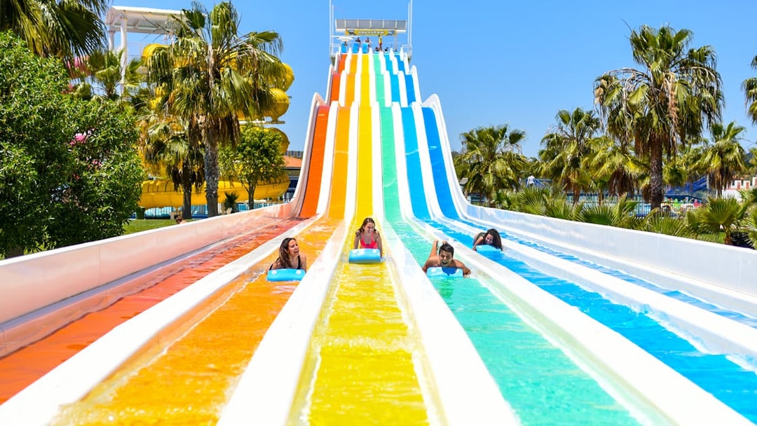 Visitors enjoying colorful water slides at Aquashow Park.