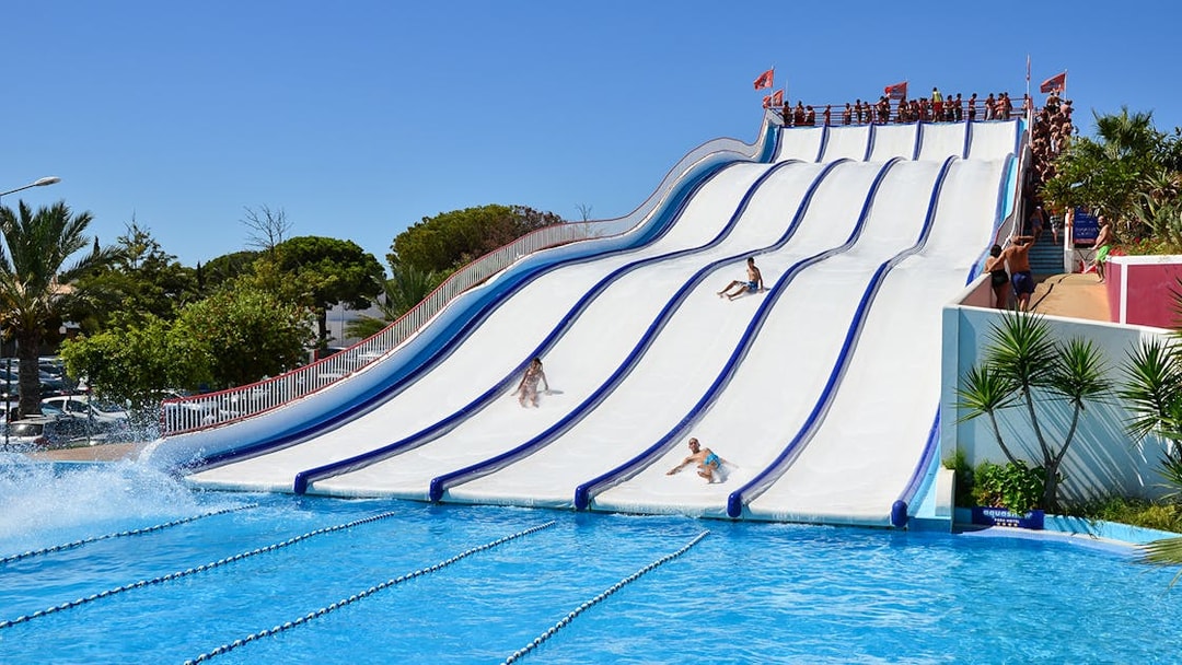 Visitors enjoying water slides at Aquashow Park, Portugal.