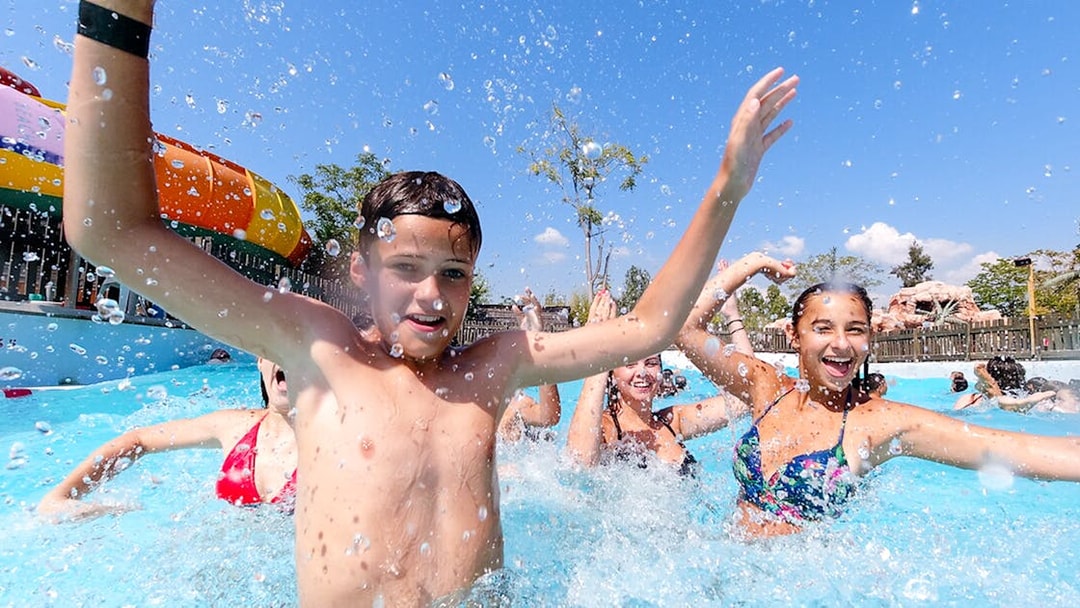 Children playing in the water at Aquasplash Antibes, enjoying a sunny day.