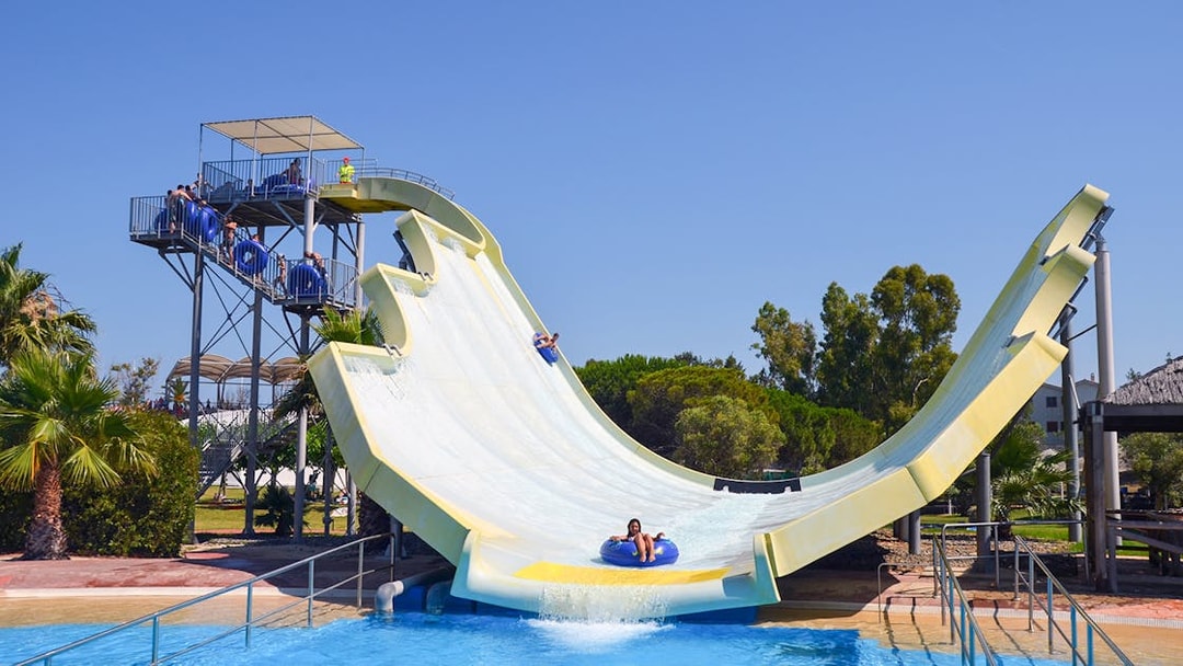 Visitors enjoying a water slide at Aquopolis Costa Daurada.