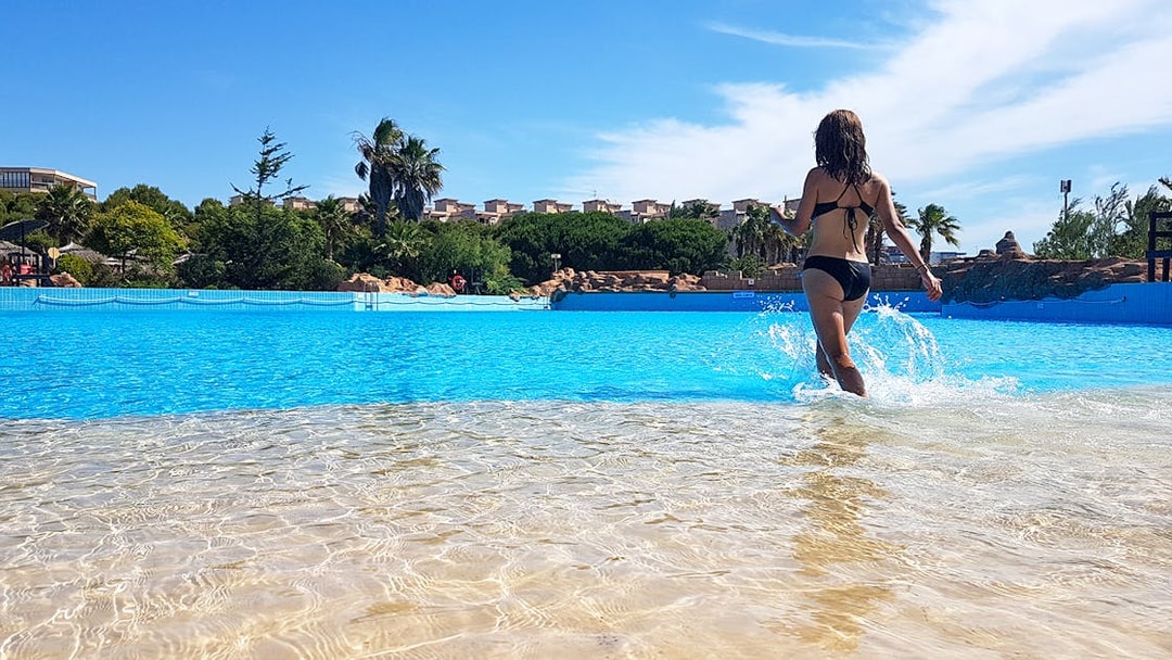 Person walking in wave pool at Aquopolis Costa Daurada, Spain.