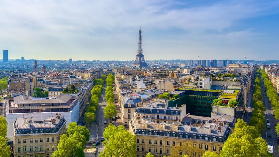 View of the Eiffel Tower from the Arc de Triomphe, Paris skyline in foreground.