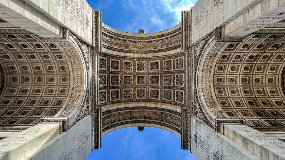 View of the Arc de Triomphe's intricate ceiling in Paris, part of an audio-guided tour.