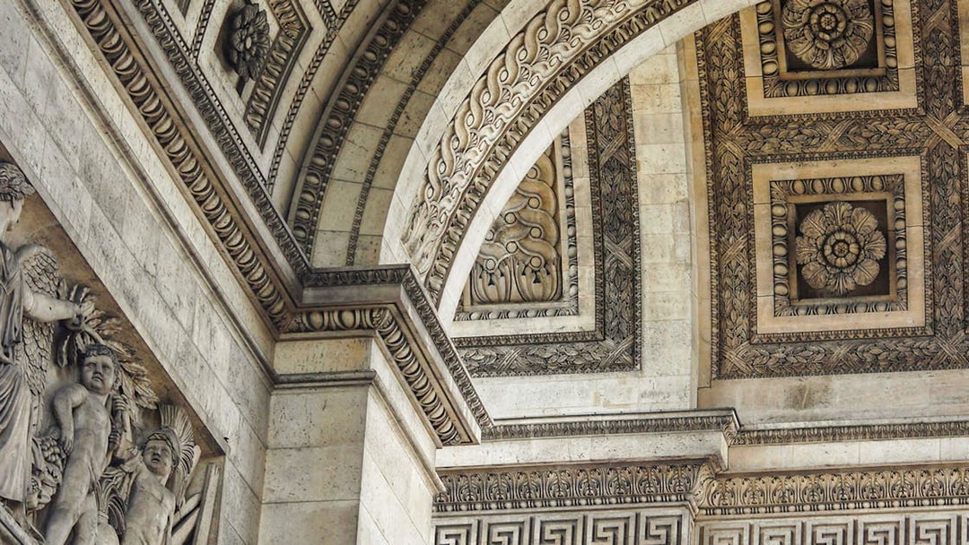 Close-up of intricate carvings and sculptures on the Arc de Triomphe in Paris.