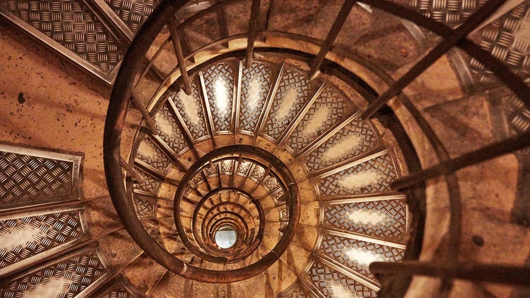 Spiral staircase inside Arc de Triomphe, Paris, viewed from above.