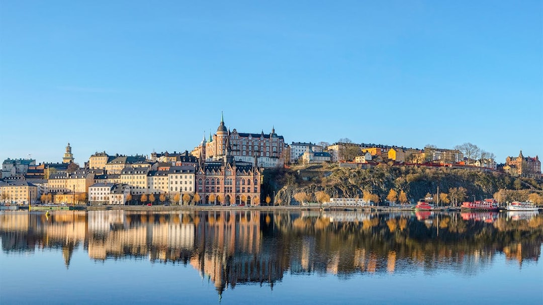 Old houses in the Södermalm district reflected in water during an Archipelago Sightseeing Cruise.