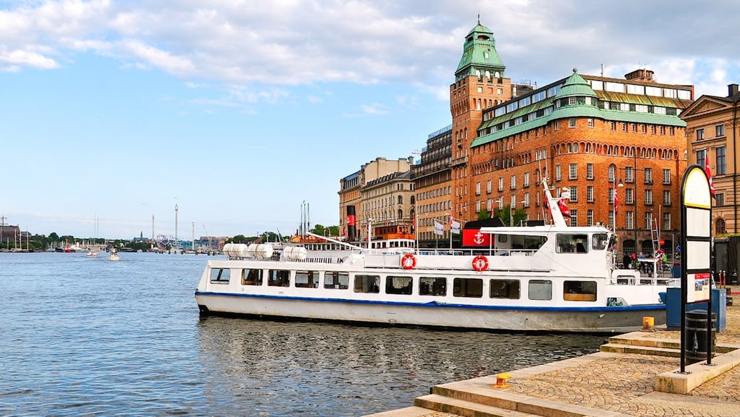 Tour boat docked near historic buildings on an archipelago sightseeing cruise.