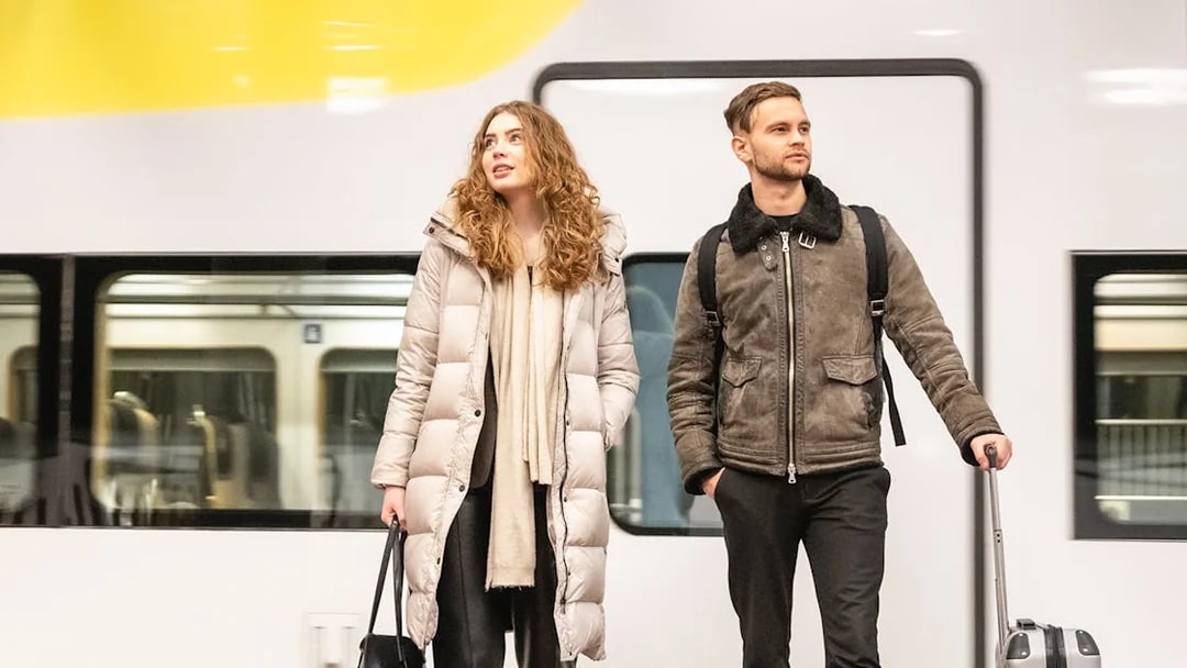 Travelers with luggage at Arlanda Express platform, Stockholm.