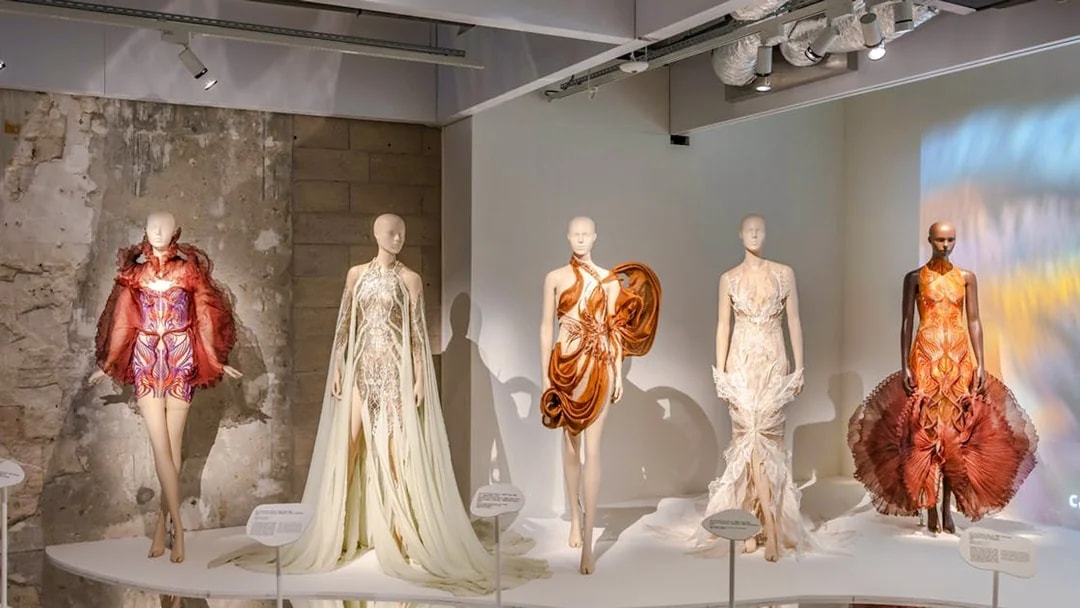 Mannequins displaying avant-garde fashion designs at ArtScience Museum exhibit.