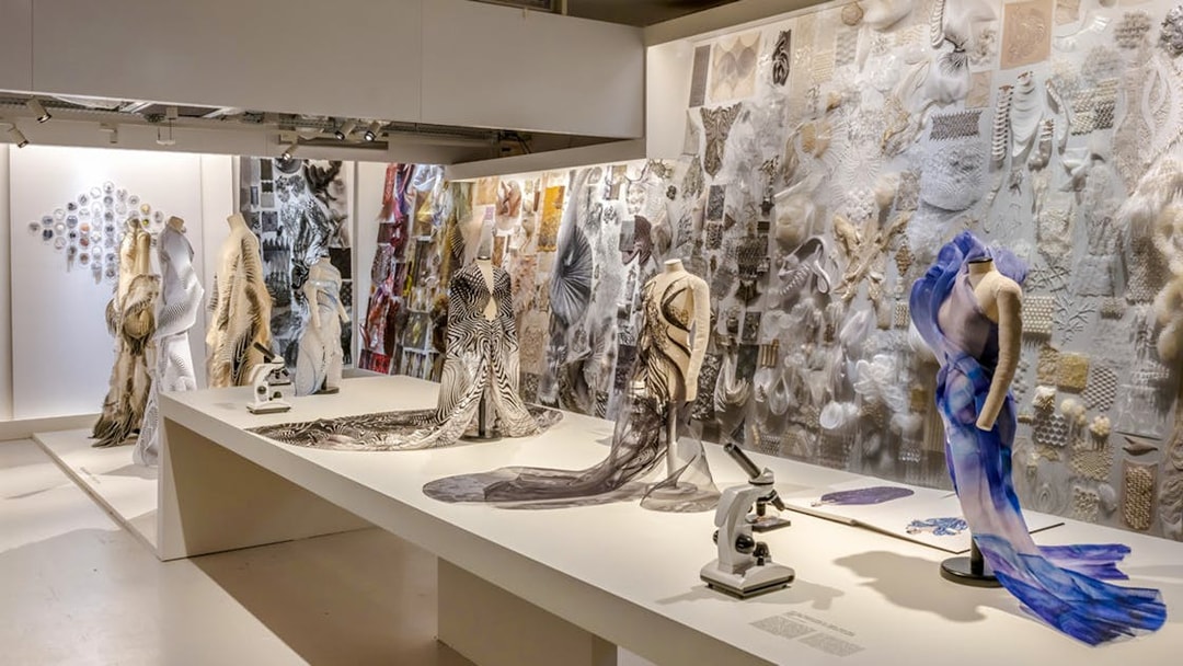 ArtScience Museum exhibit with fashion designs and microscopes on display.