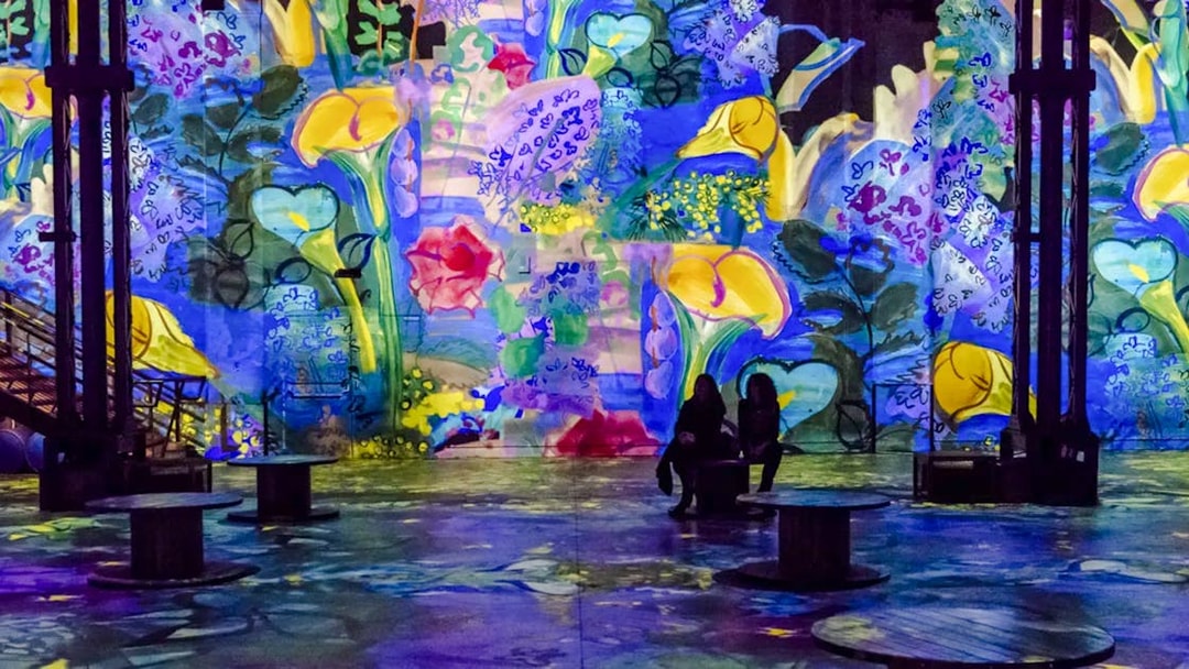 Immersive floral digital art display at Atelier Des Lumières, Paris, France.