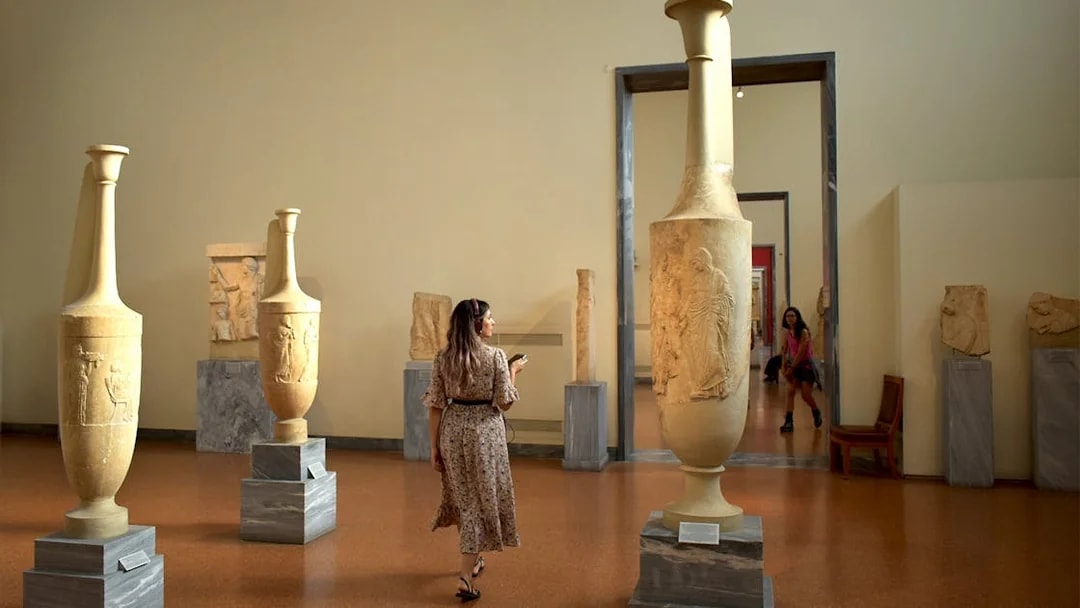 Visitor exploring ancient artifacts at the National Archaeological Museum.