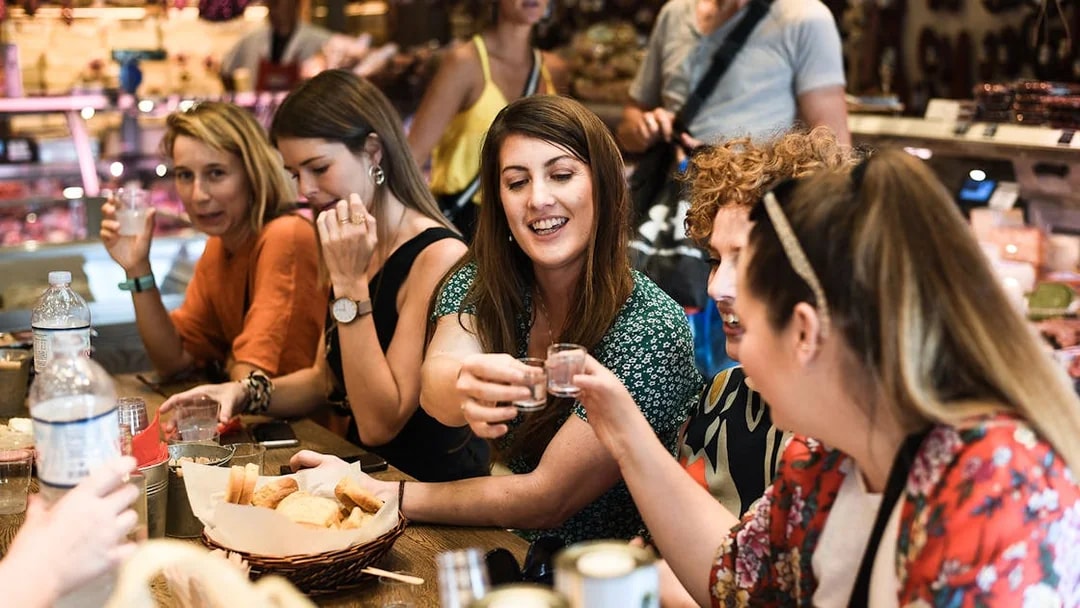 Group enjoying drinks and snacks on Athens food tour.