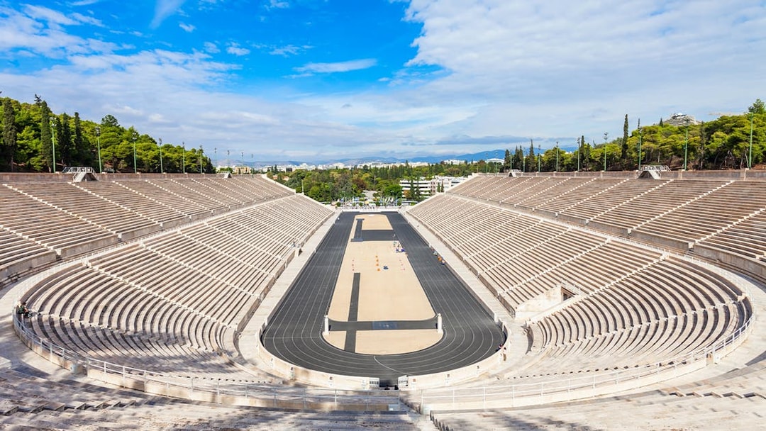 Panathenaic Stadium in Athens, Greece, with empty marble stands and a central track.