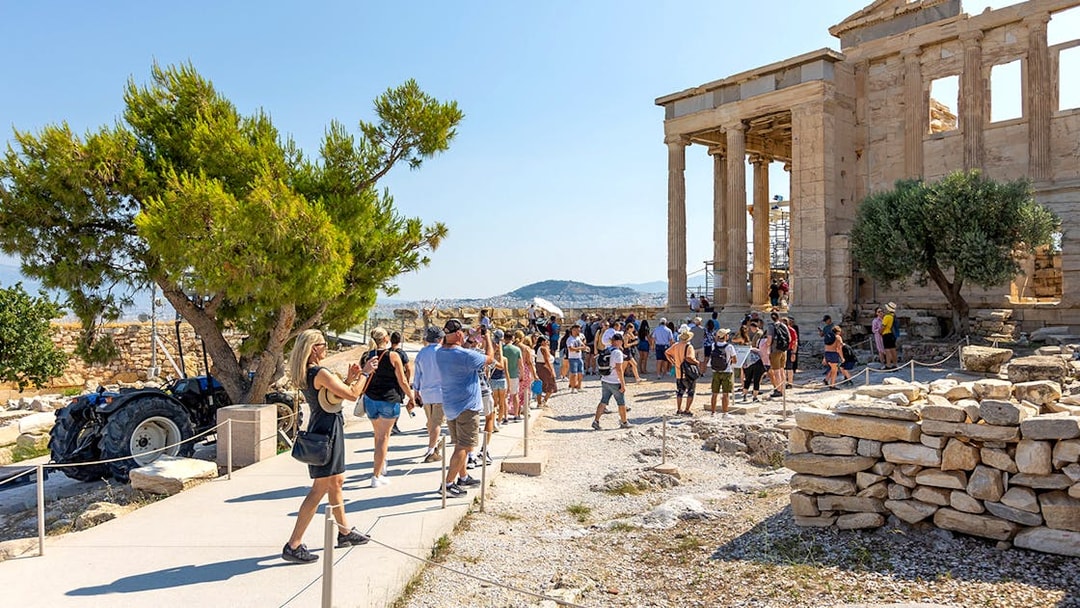 Visitors walking near the Parthenon in Athens, Greece.