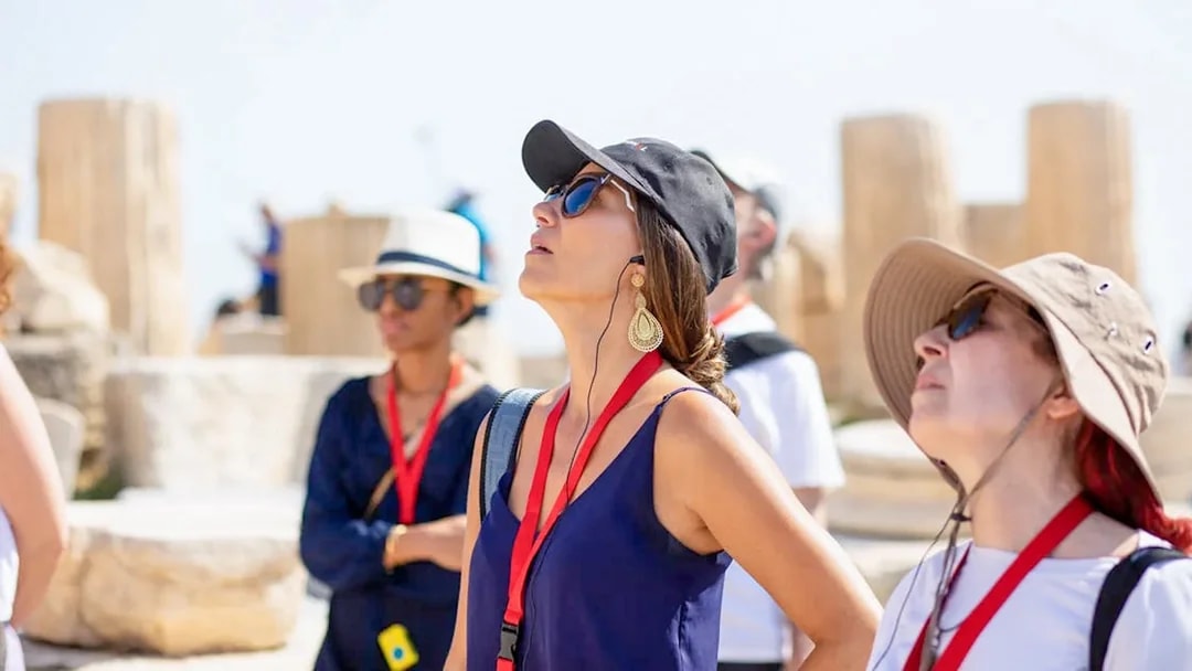 Guests using audio guides during Acropolis Parthenon tour in Athens.