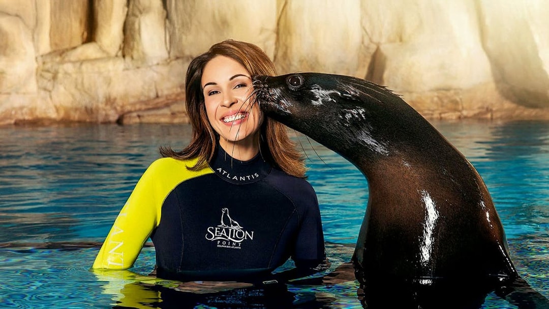 Sea lion kissing woman on cheek at Atlantis, Dubai experience.