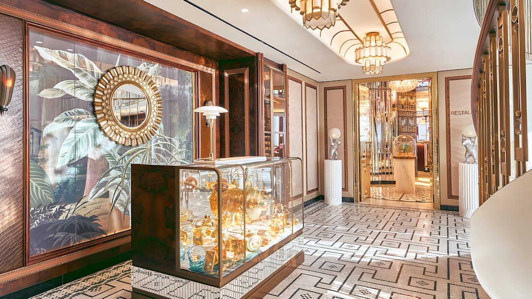 Entrance to At.Mosphere restaurant, Burj Khalifa, featuring elegant decor and mirrored walls.