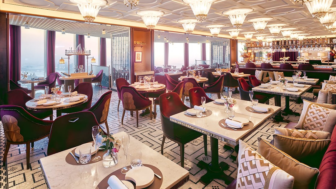 Dining area of At.Mosphere restaurant, Burj Khalifa, with elegant table settings and panoramic city views.