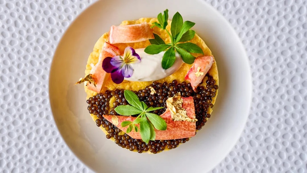 Gourmet dish with caviar and edible flowers at At.Mosphere, Burj Khalifa, Dubai.
