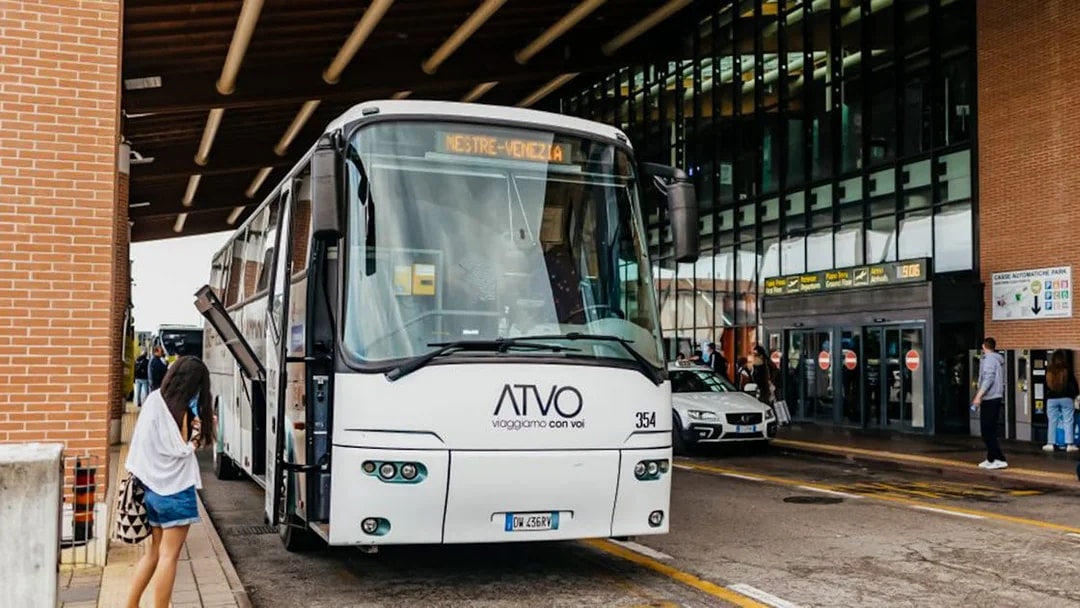 Passenger boarding bus at Treviso Airport terminal.