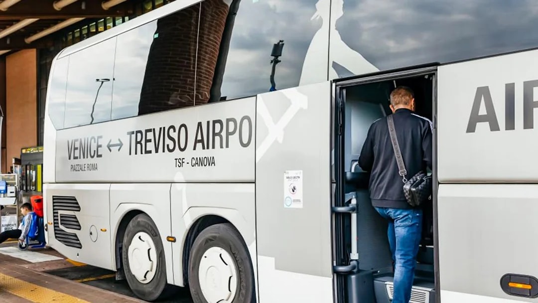 Passenger boarding ATVO airport transfer bus from Venice to Treviso.