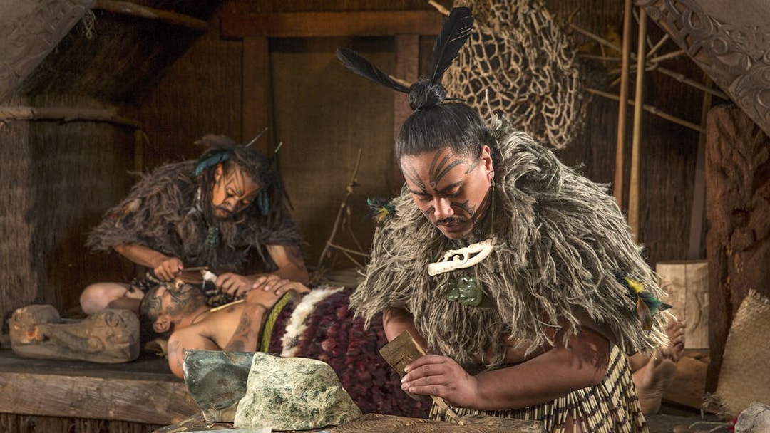 Maori cultural demonstration at Te Puia, Rotorua, with traditional carving and tattooing.