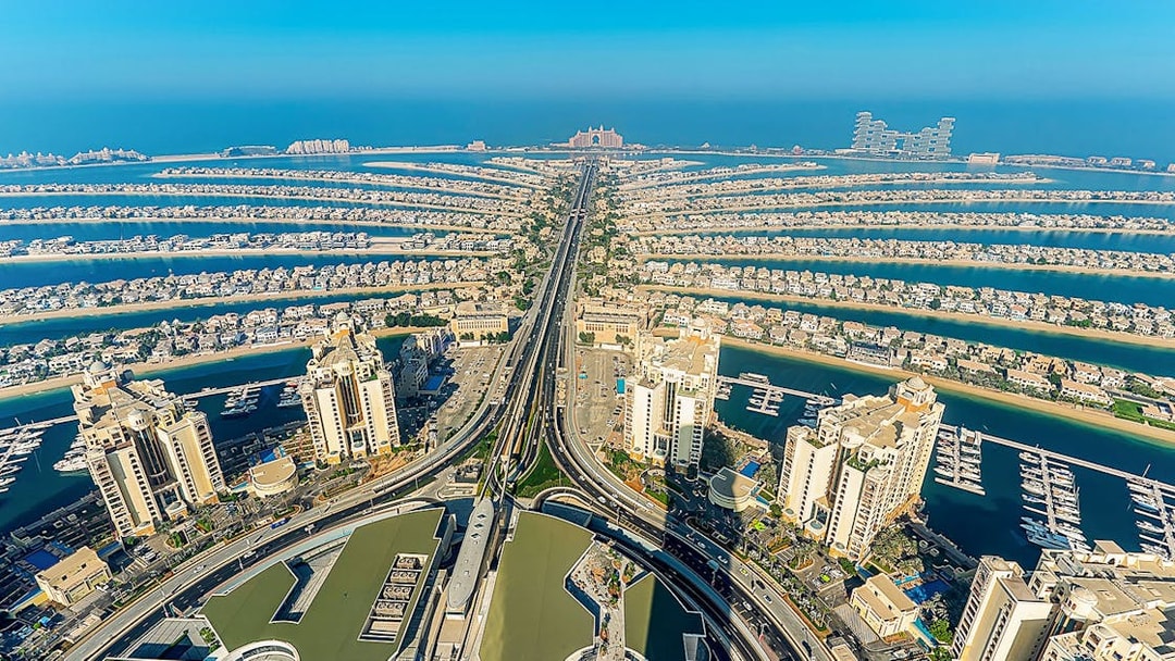 Aerial view of Palm Jumeirah in Dubai at sunrise, showcasing the iconic palm-shaped islands.