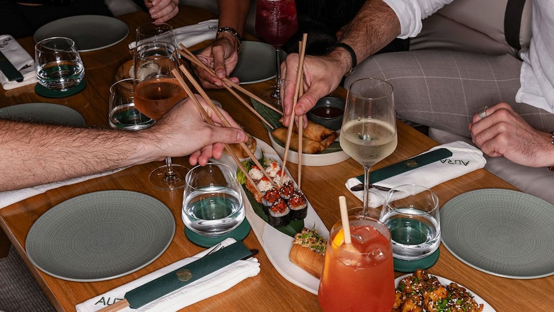 Dining experience with sushi and drinks at Aura Sky Pool.