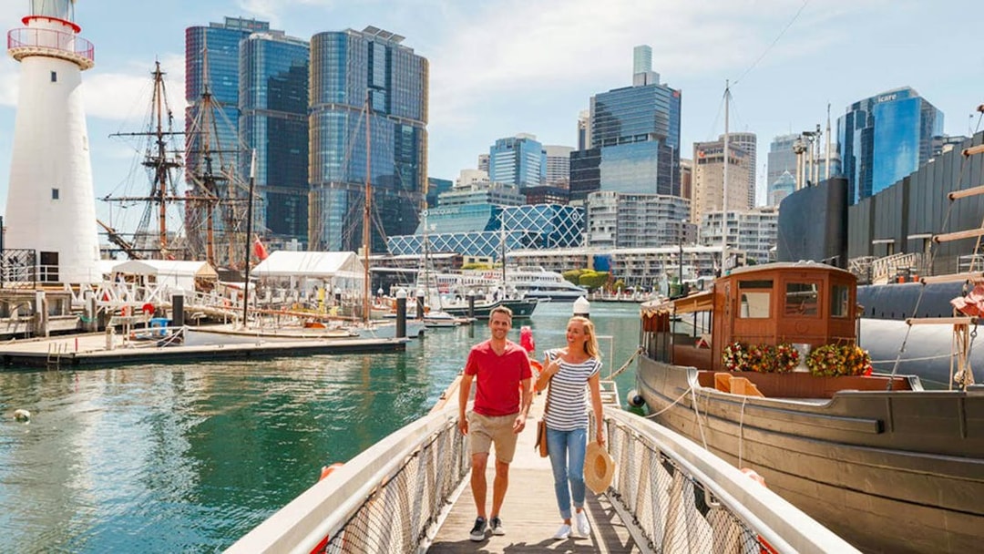 Visitors walking near ships at Australian National Maritime Museum, Sydney.